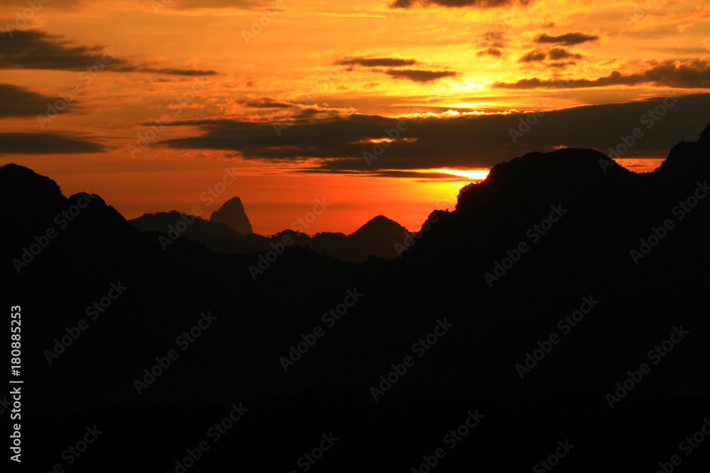 Sunset in sky and cloud, beautiful colorful twilight time with mountain silhouette