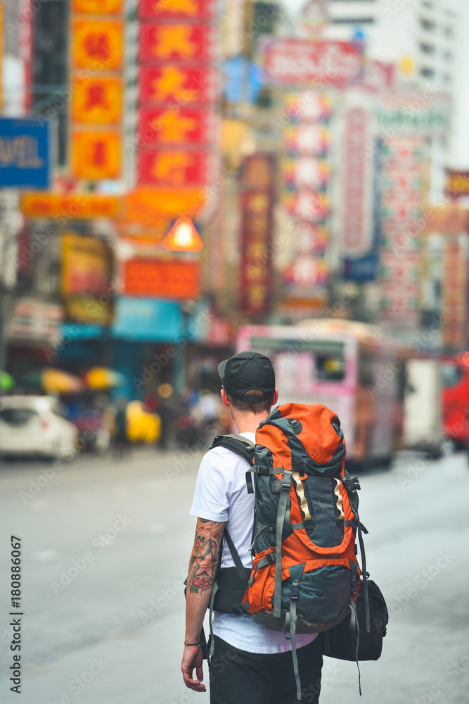 Man with a backpack in chinatown, bangkok, thailand