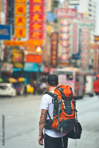 Man with a backpack in chinatown, bangkok, thailand