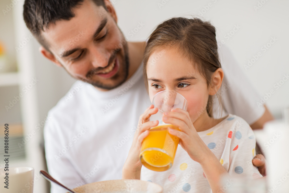 happy girl with father drinking juice at home happy girl with father drinking juice at home