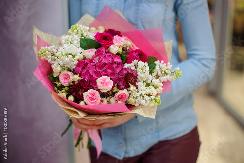 Florist holding a beautiful white and pink bouquet of flowers