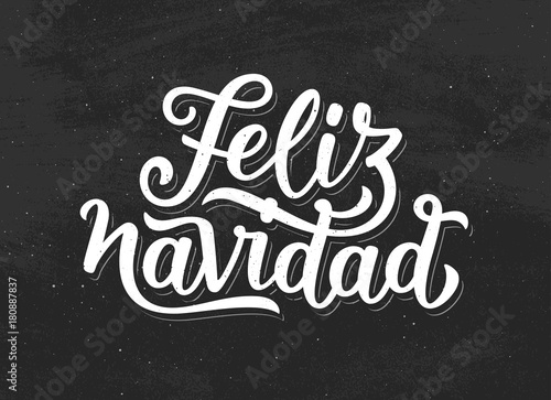 Feliz Navidad spanish Merry Christmas white text on black chalkboard background. Modern calligraphy lettering for season greetings. Vector vintage greeting card