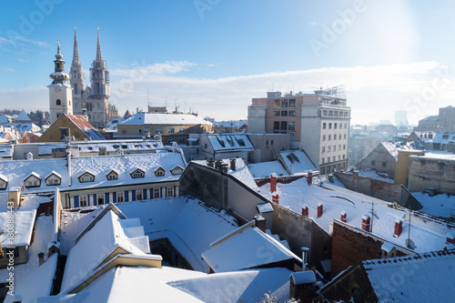 View over Zagreb during winter with snow with view to towers of church and cathedral and snowy roofs at a sunny day, Zagreb, Croatia, Europe photo