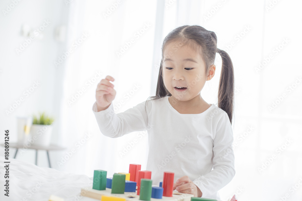 Girl playing toy with Attractive Smiling at home. Happy Family Concept. Girl playing toy with Attractive Smiling at home. Happy Family Concept.