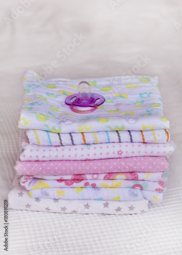 Stack of Baby Diapers and Baby Pacifier