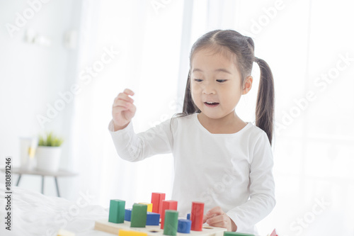 Girl playing toy with Attractive Smiling at home. Happy Family Concept.