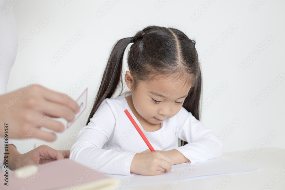 Attractive Little Girl writing Book. Dad Teaching her at home. Children Lifestyle, Education Concept. Attractive Little Girl writing Book. Dad Teaching her at home. Children Lifestyle, Education Concept.