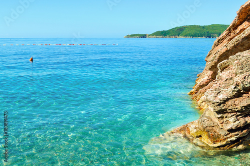 The sea view. Calm sea and large stones. Transparent water of the Adriatic Sea. Montenegro