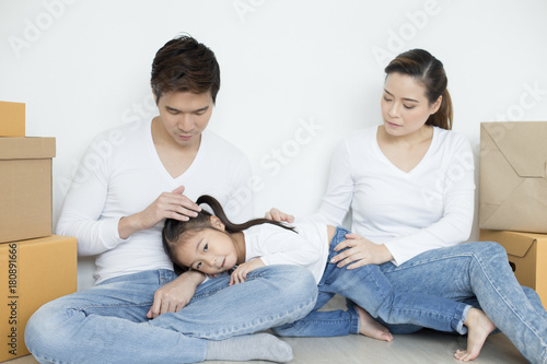 Attractive Asian family resting together. People resting when finist to move stuff at home. Happy Family Concept. photo