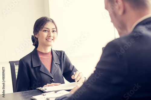 Asian Businesswoman working with businessman at office. Woman help Businessman for a Project. People working Concept. Vintage Tone.