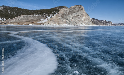 blue ice of lake Baikal, the rock and the little houses