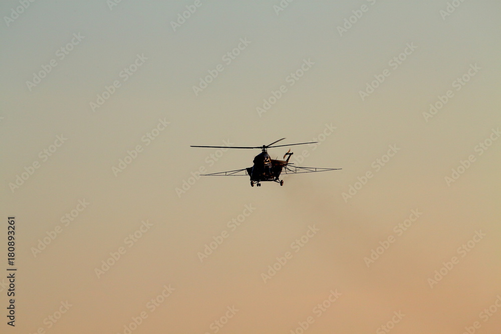 Helicopter flying in the blue evening sky Helicopter flying in the blue evening sky