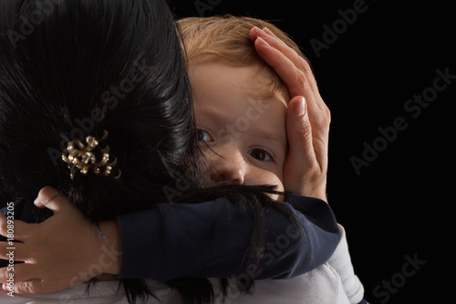 Fotografie Adoption concept, an orphan is a little boy and his new mother