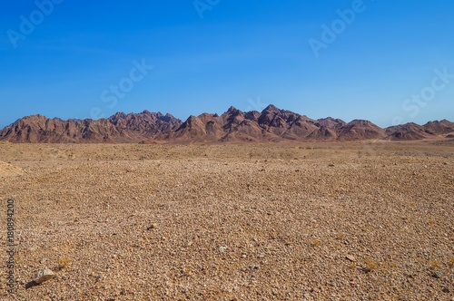 Martian landscape, desert plain against the backdrop of mountains of volcanic deposits of marine sandstone, blue sky