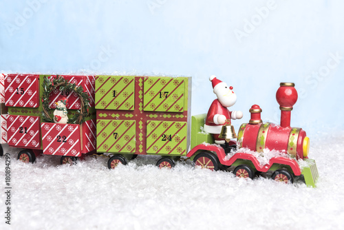 Santa Claus riding on train threw snow carriing days until christmas photo