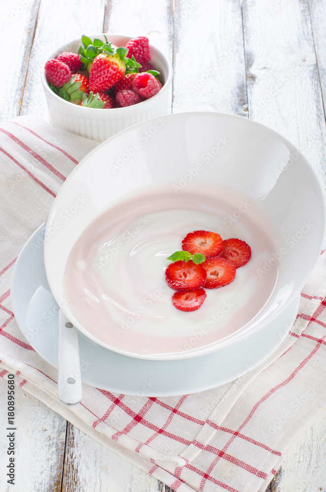 Fresh strawberry yoghurt in a bowl with fresh berries Fresh strawberry yoghurt in a bowl with fresh berries