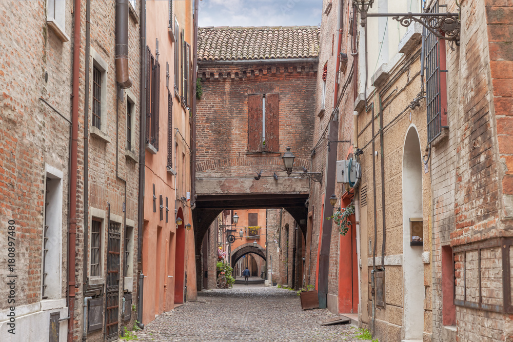 Old narrow medieval street of the center of Ferrara