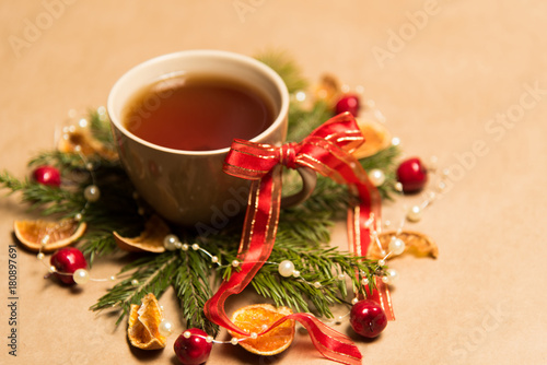 Cup of black tea, Christmas toys, gifts and decorations on craft background