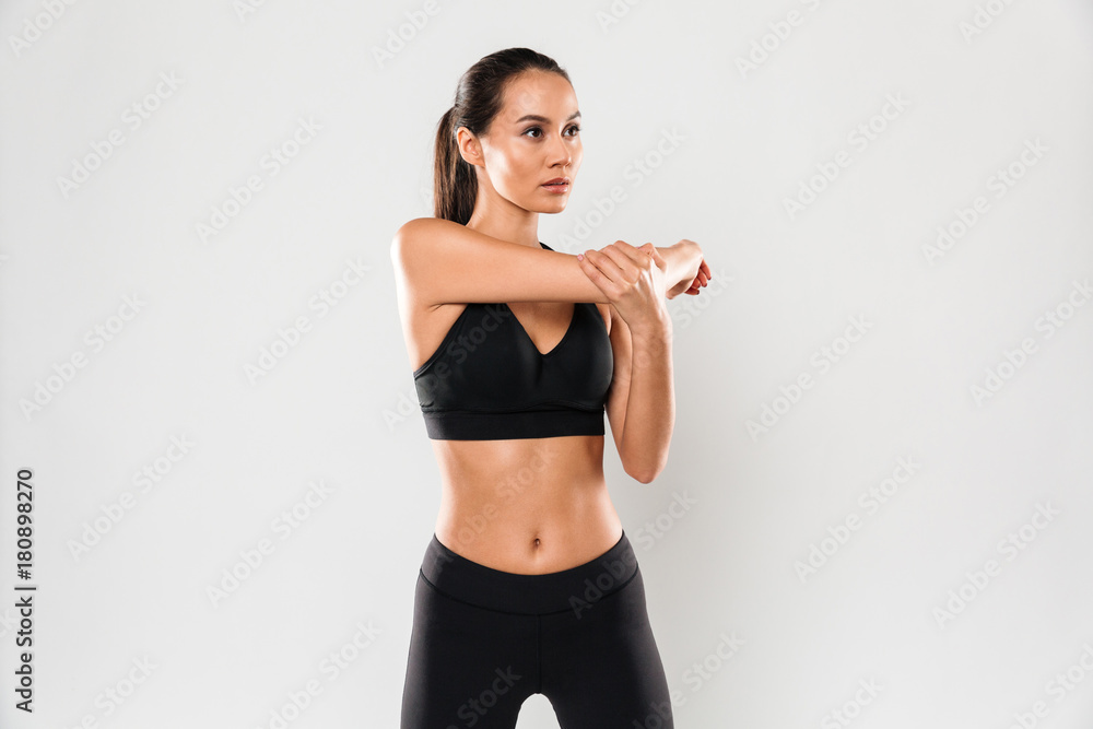 Concentrated young sports woman make stretching exercises Concentrated young sports woman make stretching exercises