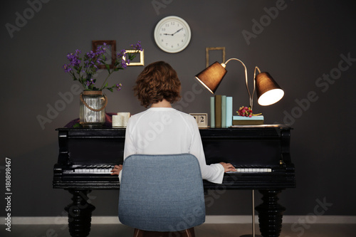 Woman playing piano at home