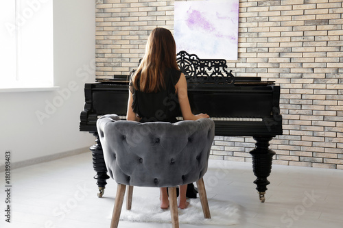 Woman playing piano at home