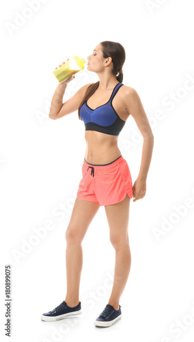 Beautiful young woman drink...