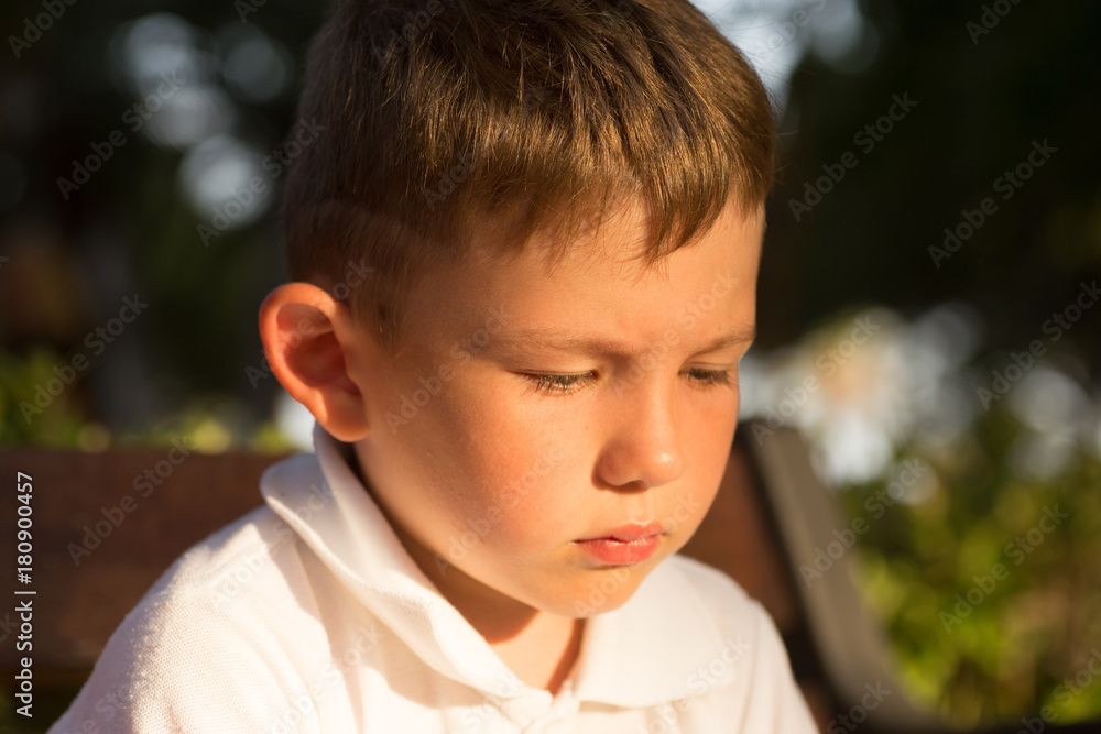 Beautiful little brunet hair boy, has serious face, happy eyes. Child portrait. Summer time. Close up. Beautiful little brunet hair boy, has serious face, happy eyes. Child portrait. Summer time. Close up.