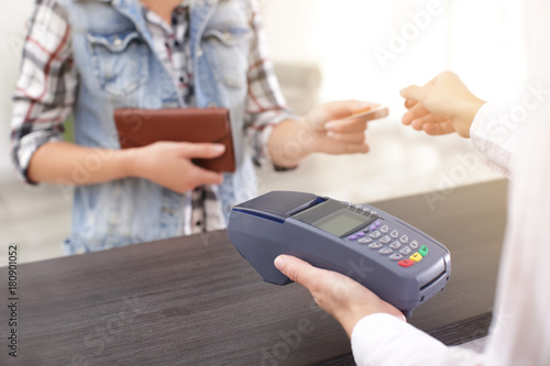 Woman using bank terminal f...