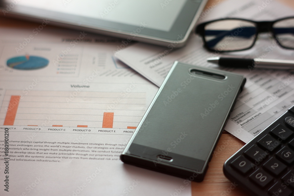 Financial paper and work station with tablet on working table, business concept. Financial paper and work station with tablet on working table, business concept.