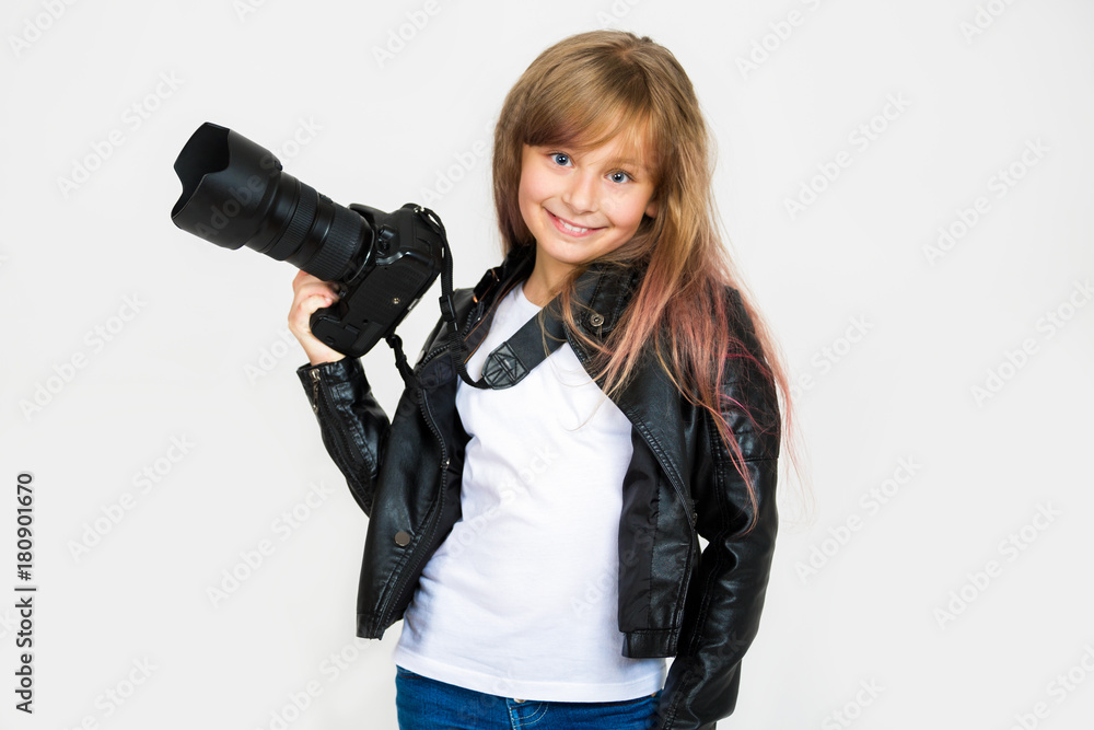 Portrait of a beautiful smiling girl. A child with a mirror camera on a light background