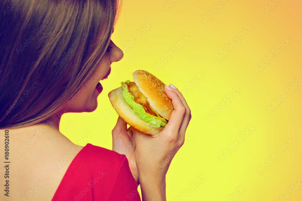 Woman bites burger back close up portrait Woman bites burger back close up portrait