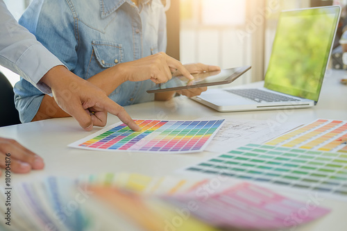 Graphic design and color swatches and pens on a desk. Architectural drawing with work tools and accessories