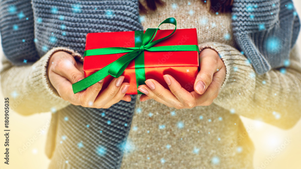 Fototapeta premium Red christmas present in female hands.