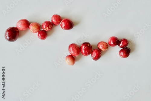 A lot of tasty and healthy red cranberries on the white background