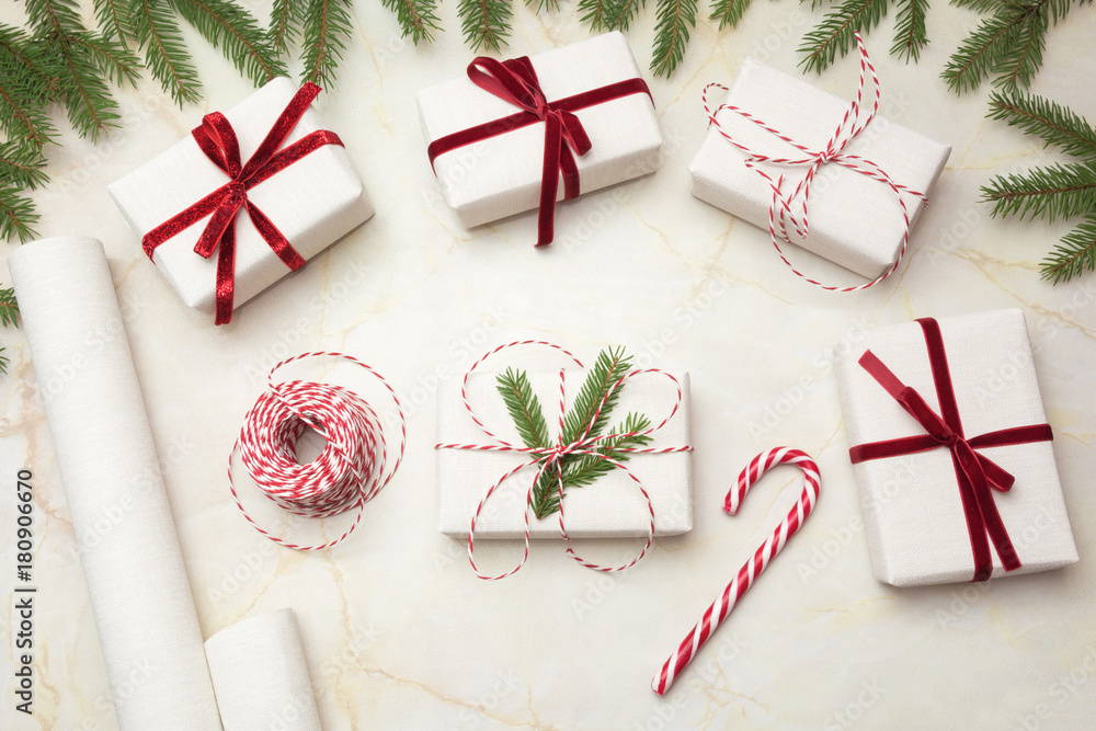 Christmas gift boxes wrapped in white craft paper and decorative red ...