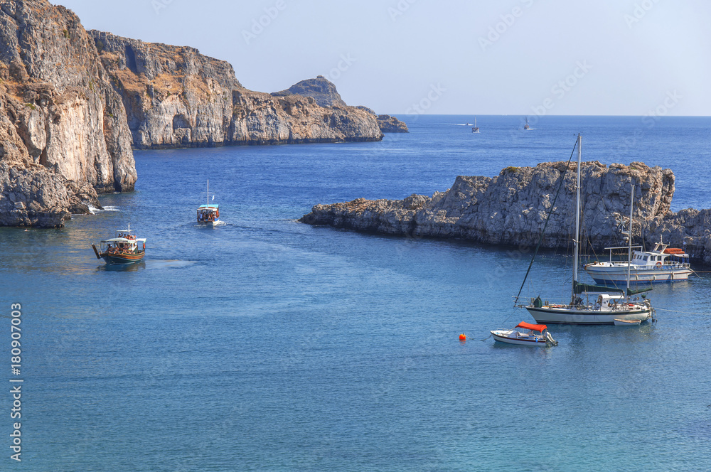 Sain Paul bay of city Lindos at iceland Rhodes with several docked boat on sea