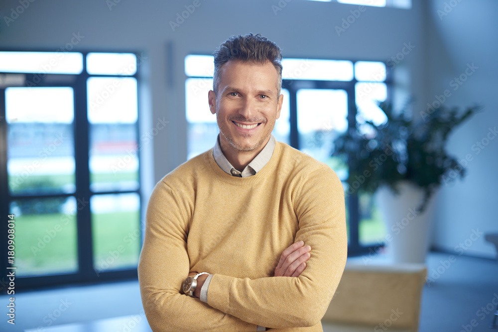 Confident mature businessman smiling to you Confident mature businessman smiling to you