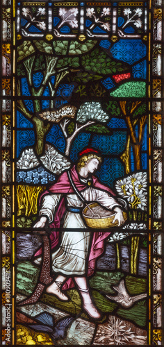 LONDON, GREAT BRITAIN - SEPTEMBER 19, 2017: The Parable of the Sower on the stained glass in St Mary Abbot's church on Kensington High Street.