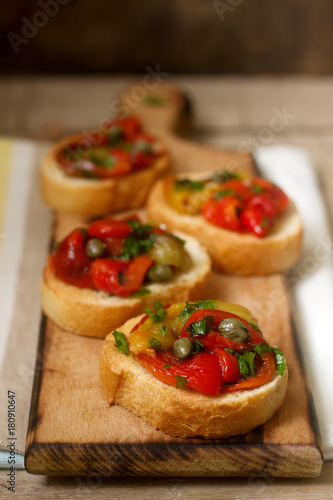 Fresh and tasty bruschetta with pickled bell pepper, capers and parsley.