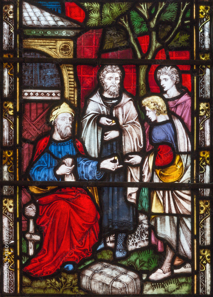 LONDON, GREAT BRITAIN - SEPTEMBER 19, 2017: The Parable of Talents on the stained glass in St Mary Abbot's church on Kensington High Street.