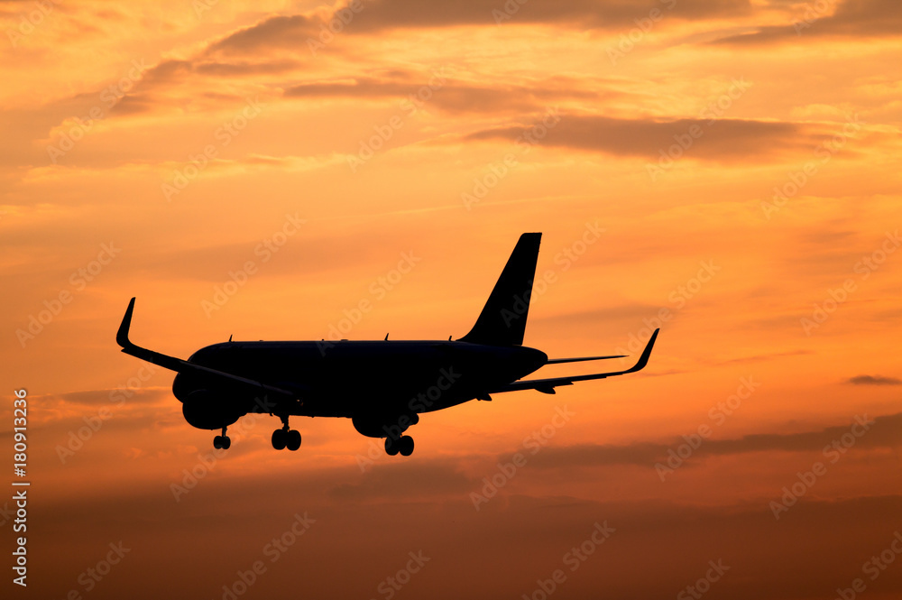 Airplane landing at sunset Airplane landing at sunset