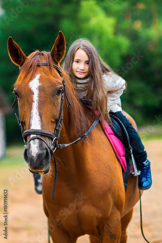 girl teenager rolls on her favorite horse, best friends.