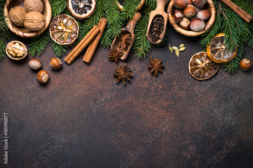 Christmas spices and nuts on rusty stone table. Top view copy space .