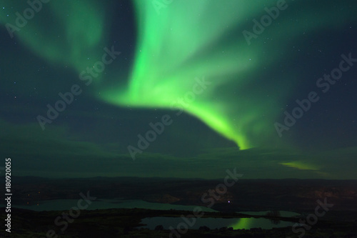 In the night sky the Aurora reflected in a lake. © Moroshka