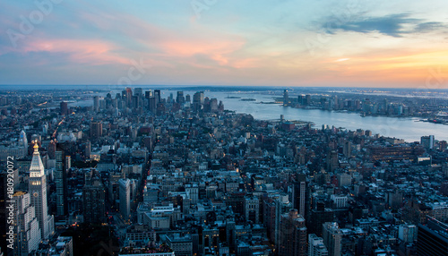 Aerial view of Manhattan New York skyline at sunset, during the blue hours, with lights of skyscrapers turning on.