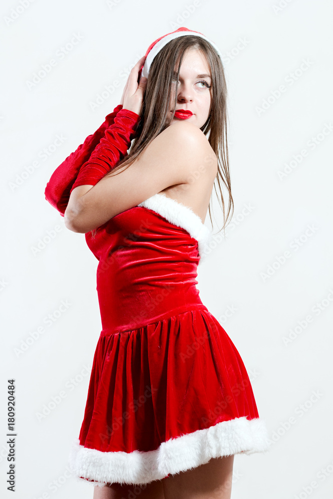 Christmas new year concept sexy girl in Santa Claus costume on white background Christmas new year concept sexy girl in Santa Claus costume on white background