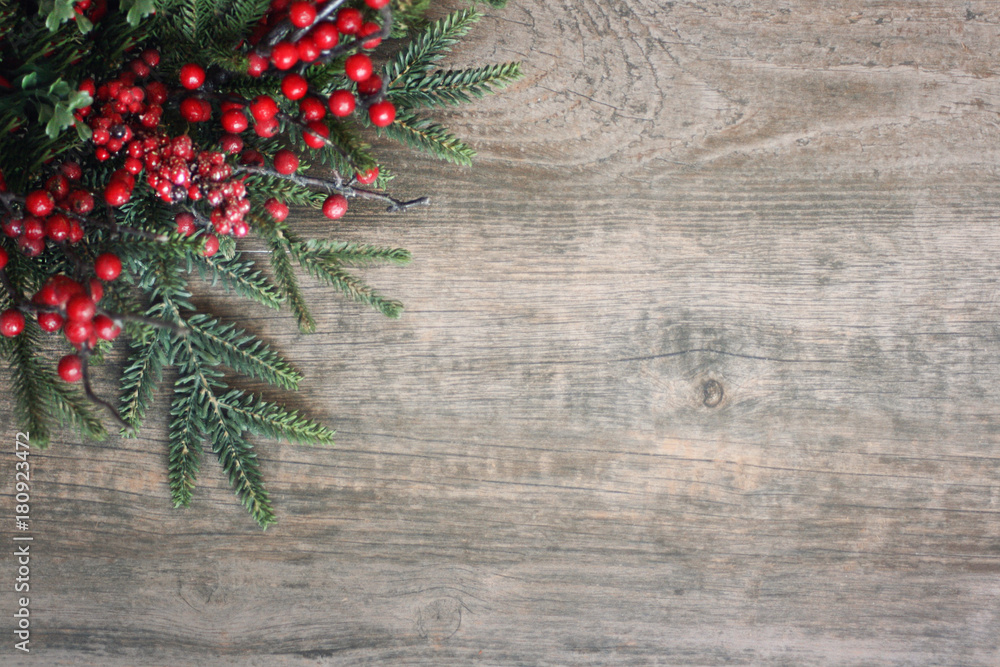 Christmas Evergreen Branches and Berries in Corner Over Rustic Wood