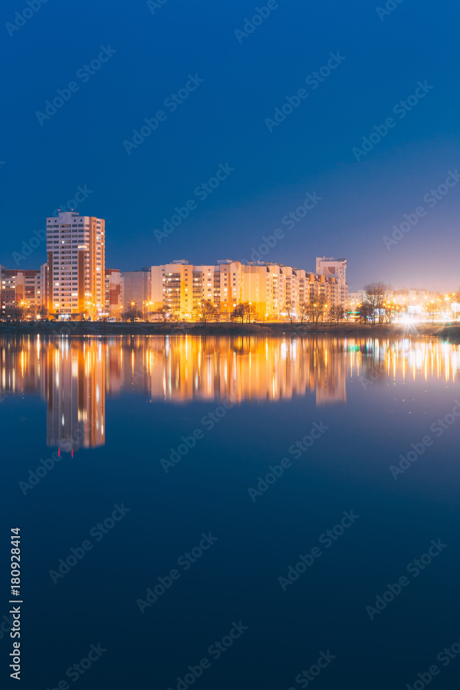 Night View Of Urban Residential Area Overlooks To City Lake Or River And Park In Evening Illumination,