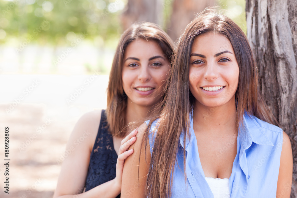 Two Beautiful Ethnic Twin Sisters Portrait Outdoors. Two Beautiful Ethnic Twin Sisters Portrait Outdoors.