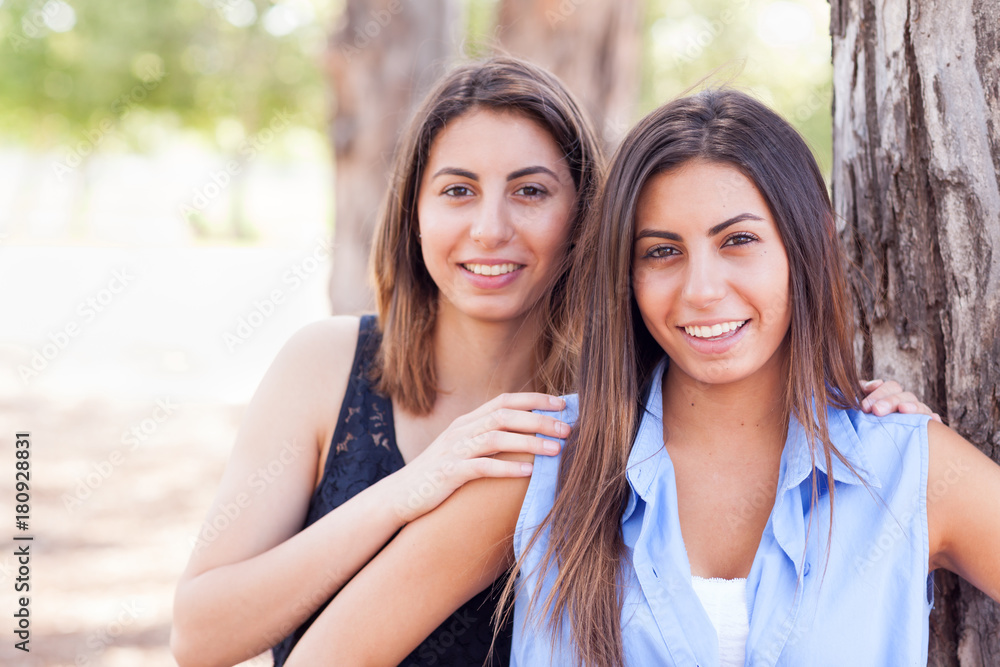 Two Beautiful Ethnic Twin Sisters Portrait Outdoors. Two Beautiful Ethnic Twin Sisters Portrait Outdoors.